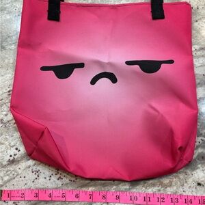Pink Tote Bag with Grumpy Face Design with matching pencil case.